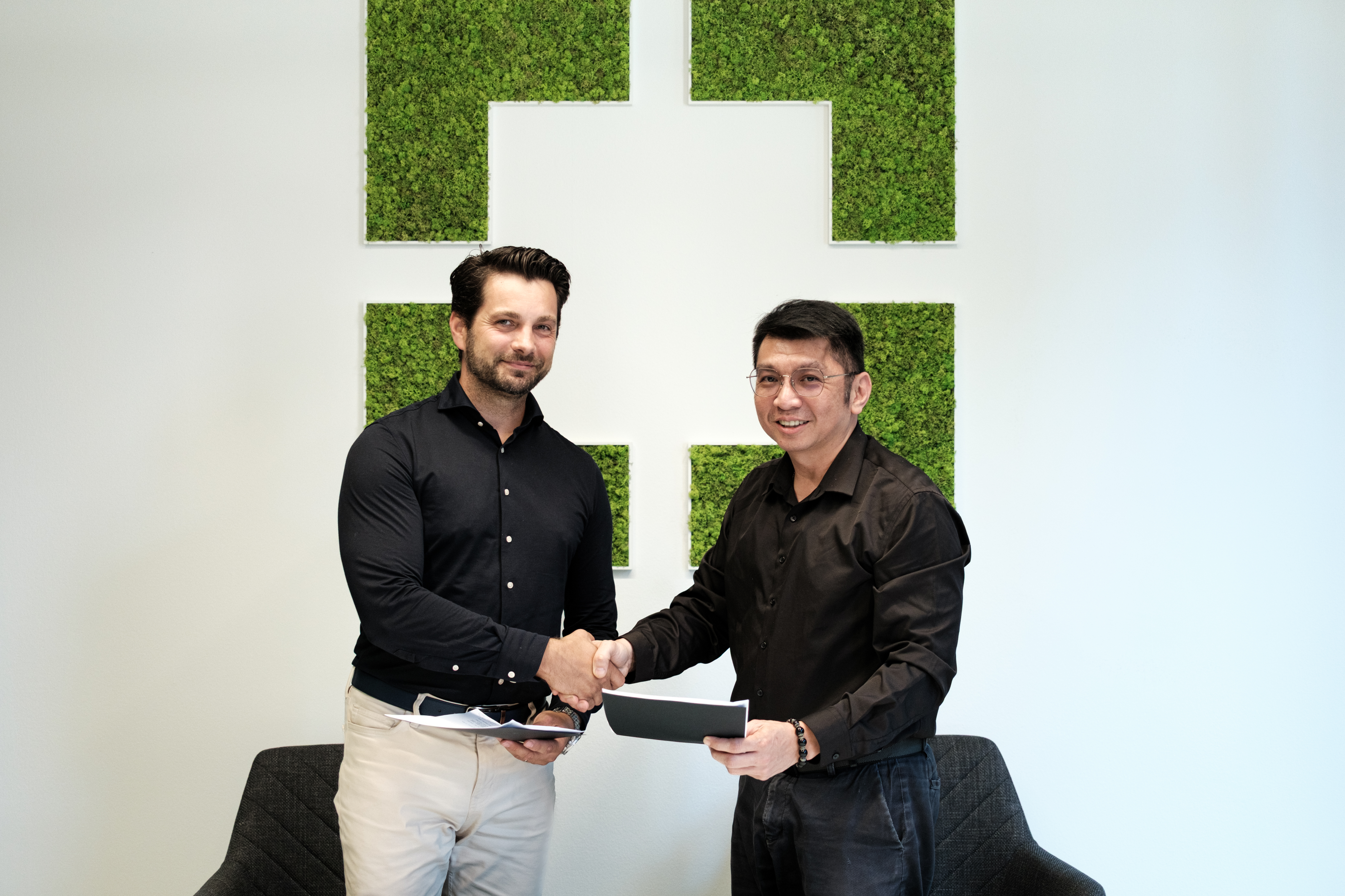 GoodVision and TTS Group leaders shaking hands after signing investment and partnership agreement.