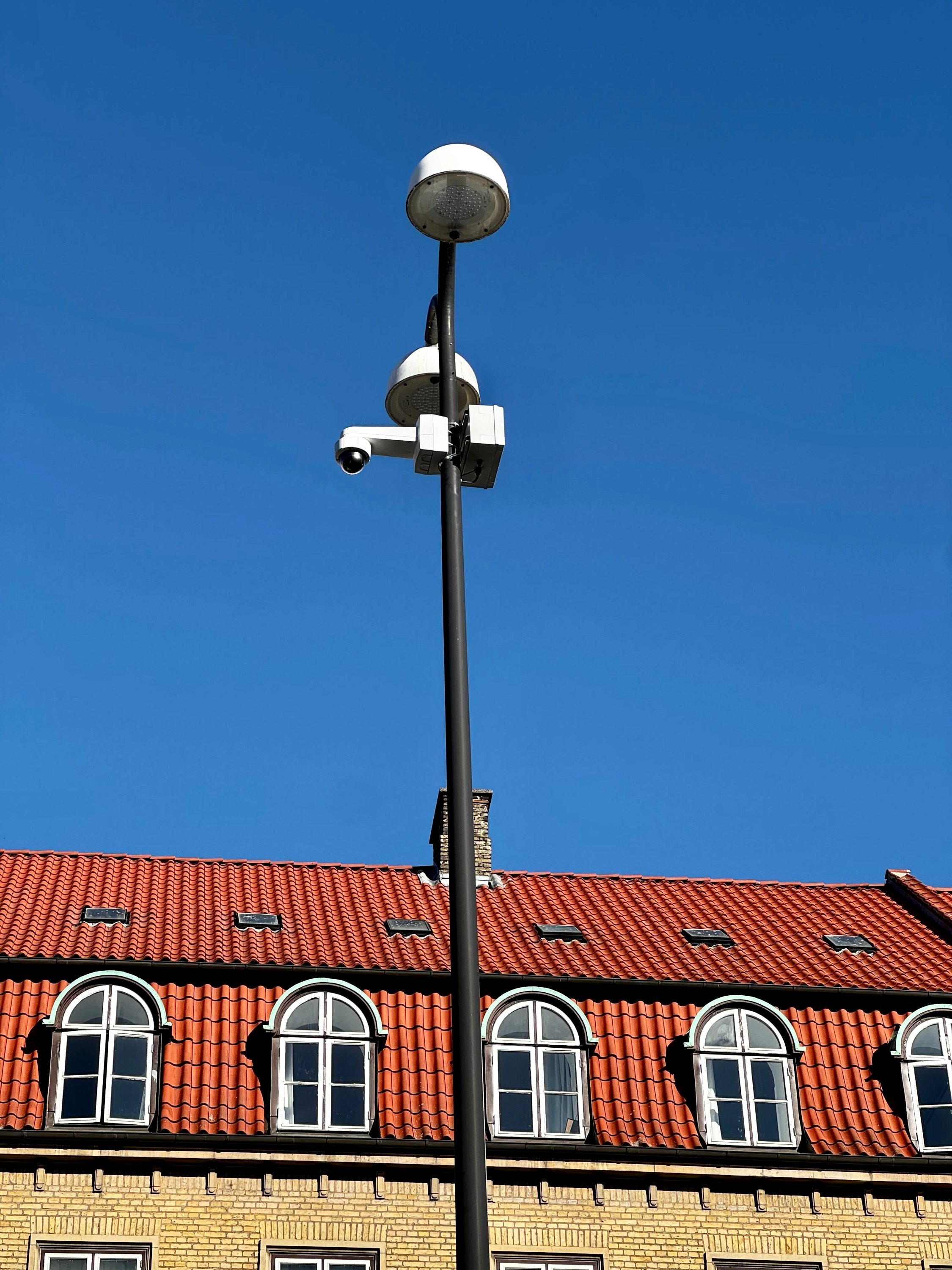 Pole-mounted AI camera system for accessible parking monitoring in Aarhus, Denmark - edge processing technology for real-time traffic analytics