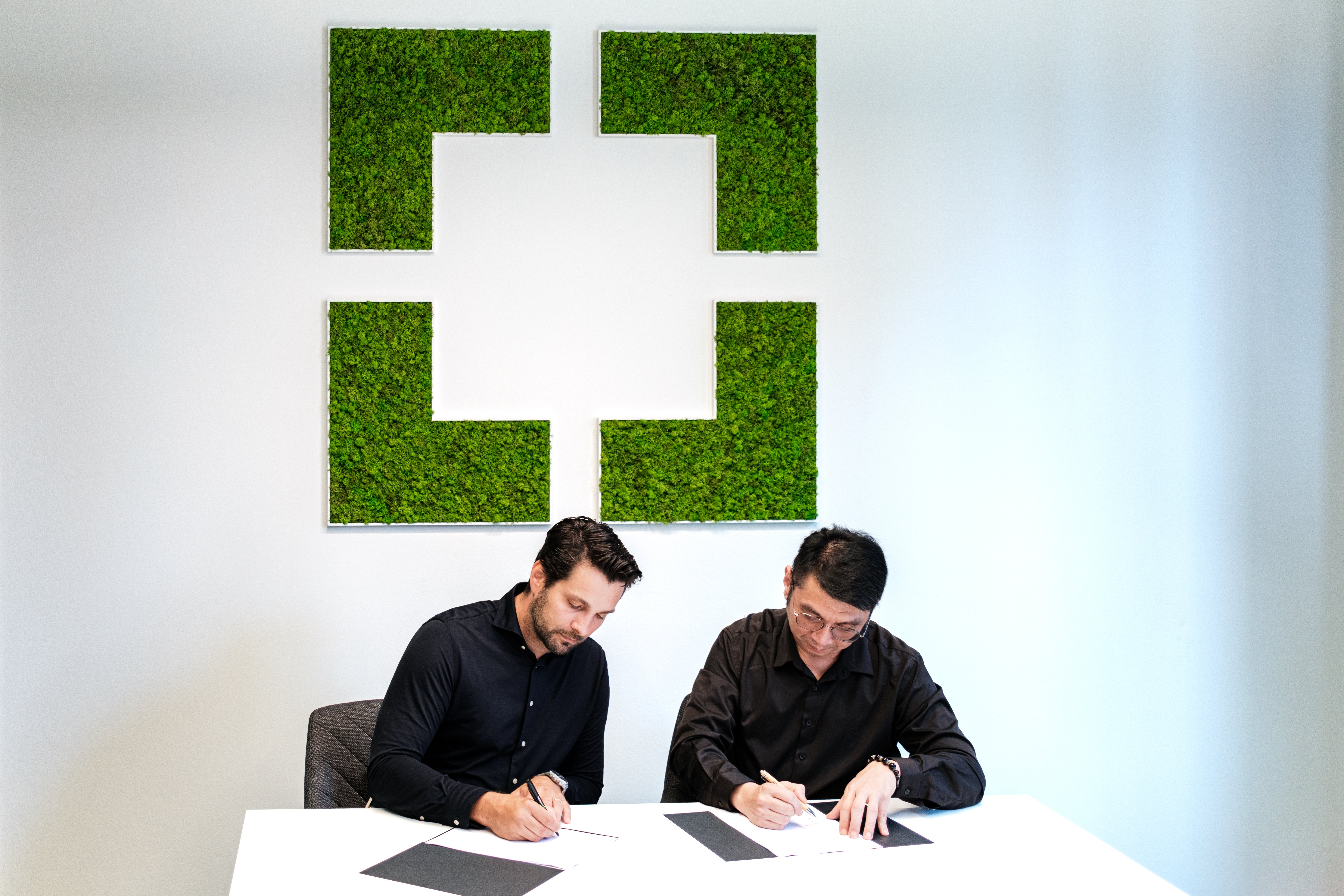 GoodVision and TTS Group executives signing official investment documents to expand AI-powered traffic analytics in Asia.